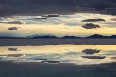 Sunset sky reflected in brine pools on the Salar
